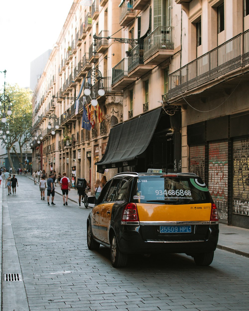 blue car parked beside building during daytime