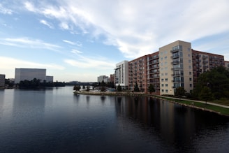 body of water near city buildings during daytime
