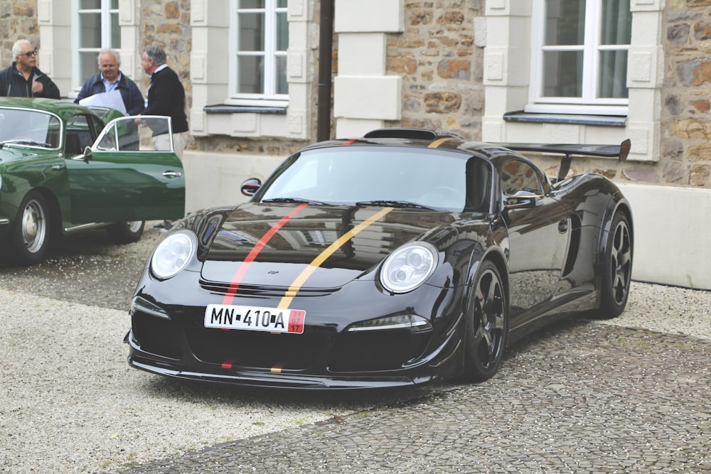 black porsche 911 parked near building during daytime