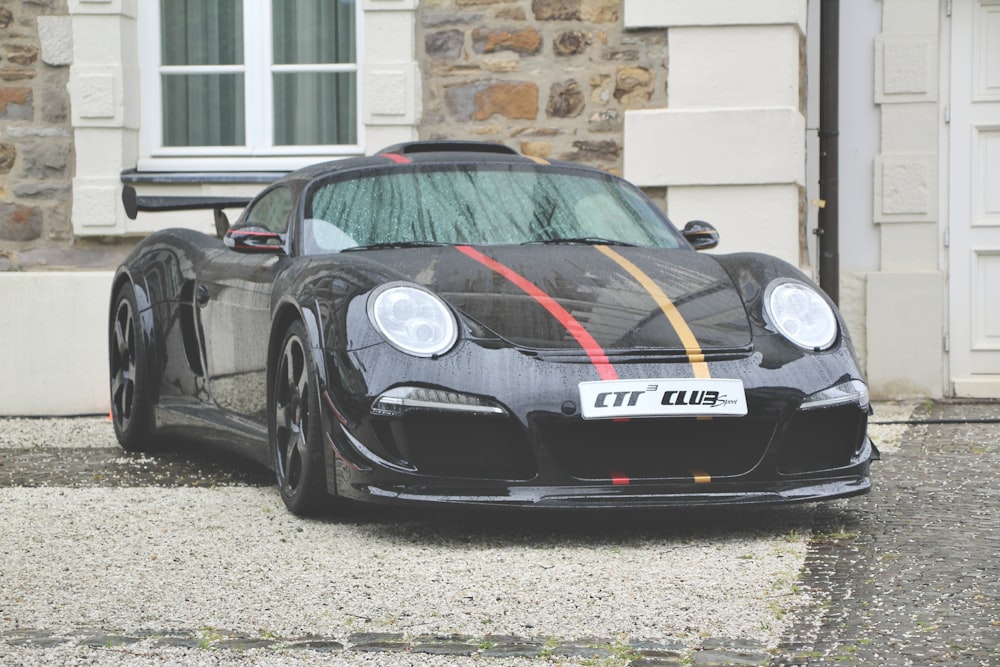 black porsche 911 parked on gray concrete pavement during daytime