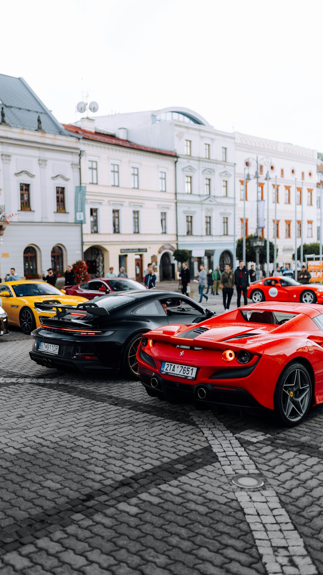 red ferrari sports car parked on street during daytime