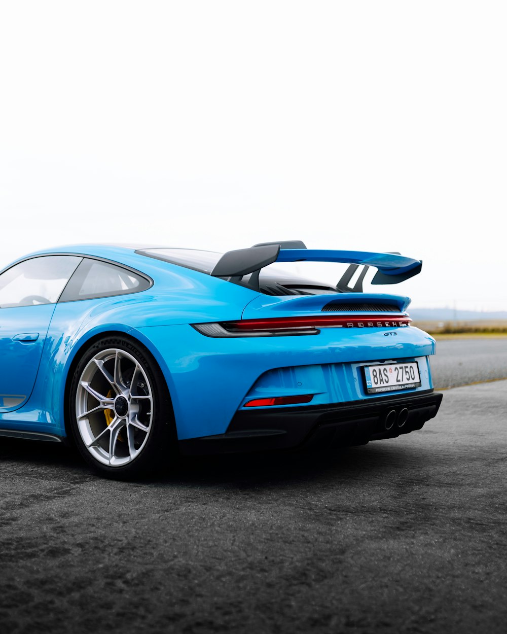 blue porsche 911 on road