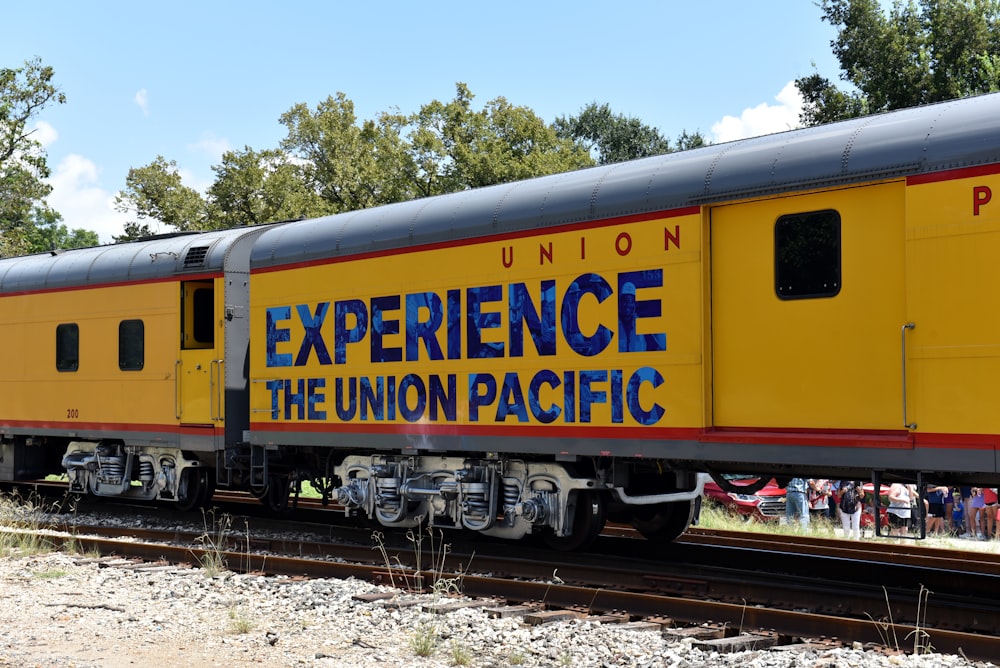 yellow and black train on rail tracks