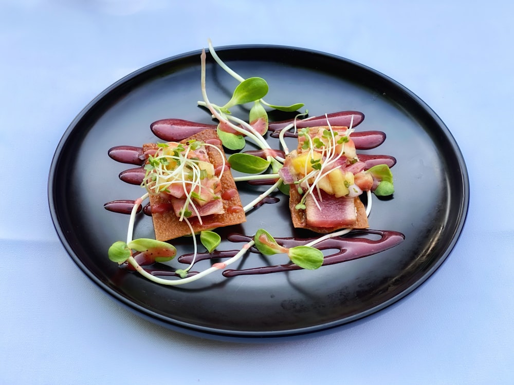 sliced meat with vegetable on black round plate