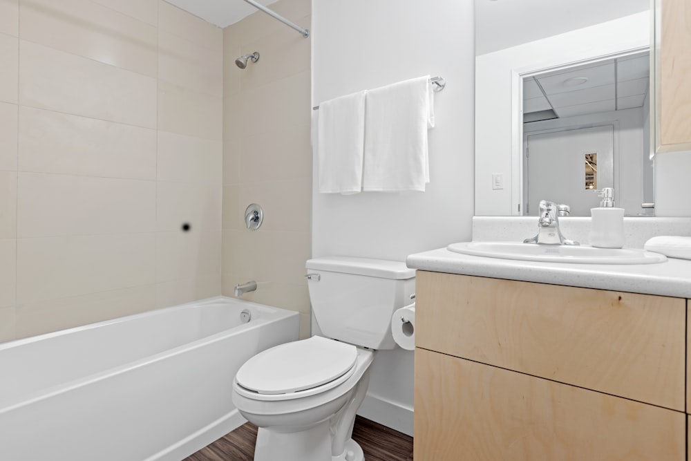 white ceramic toilet bowl near white ceramic sink