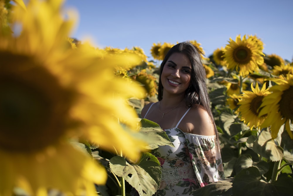 a woman standing in a field of sunflowers