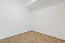 white wall paint near brown wooden parquet floor