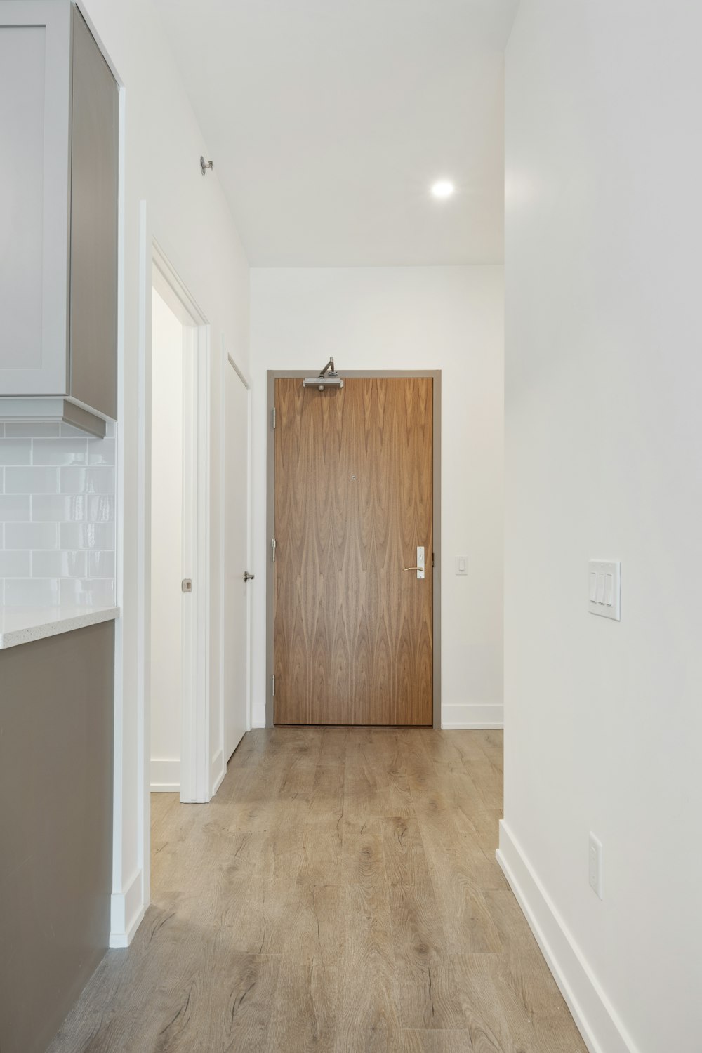 brown wooden door near white wall