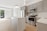 A modern kitchen with dark grey cabinets and beige accents.