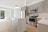 A modern kitchen with dark grey cabinets and beige accents.