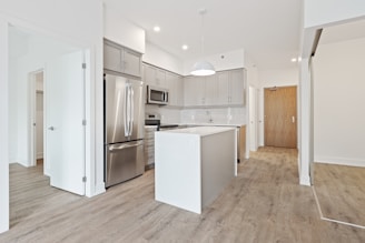 white top mount refrigerator beside white wooden kitchen cabinet