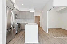 white wooden kitchen cabinet near white wall