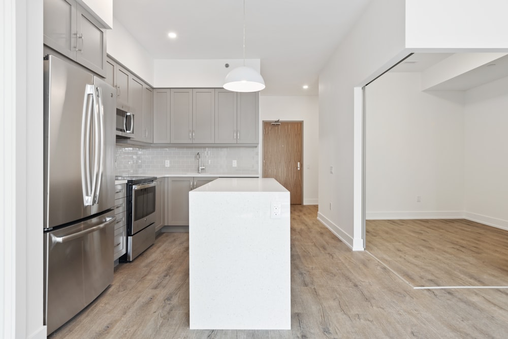 white wooden kitchen cabinet near white wall