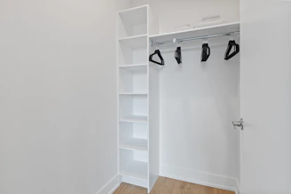 white wooden shelf with black and white shoes