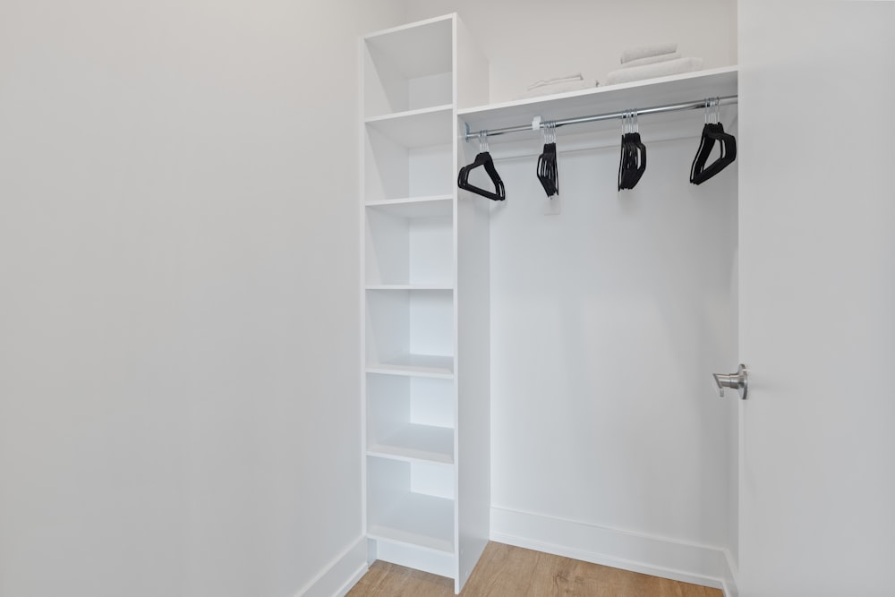 white wooden shelf with black and white shoes