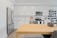 A modern kitchen featuring a sleek stainless steel refrigerator with fresh produce inside.