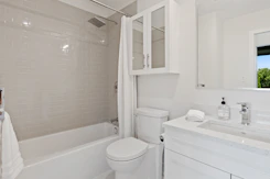 white ceramic bathtub near white ceramic bathtub