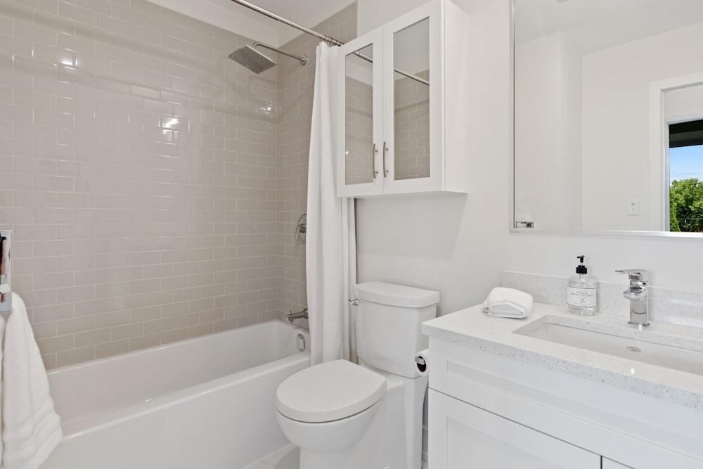 white ceramic bathtub near white ceramic bathtub