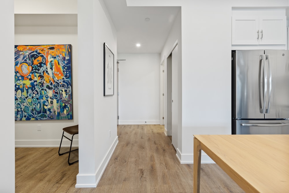 brown wooden table near white wall