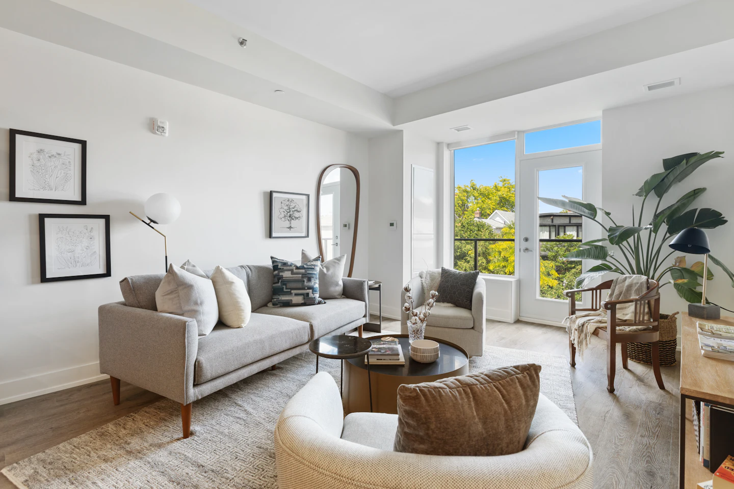 After: Light-filled living room with a white sofa and wood floors