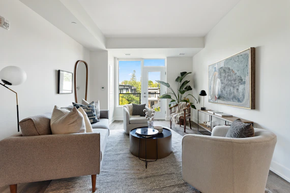 living room with white sofa and green potted plant