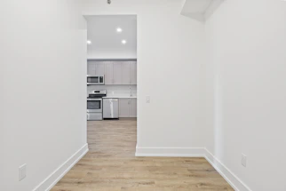 Sleek kitchen corner with smart cabinetry in a 2 BHK apartment showcasing efficient space use.