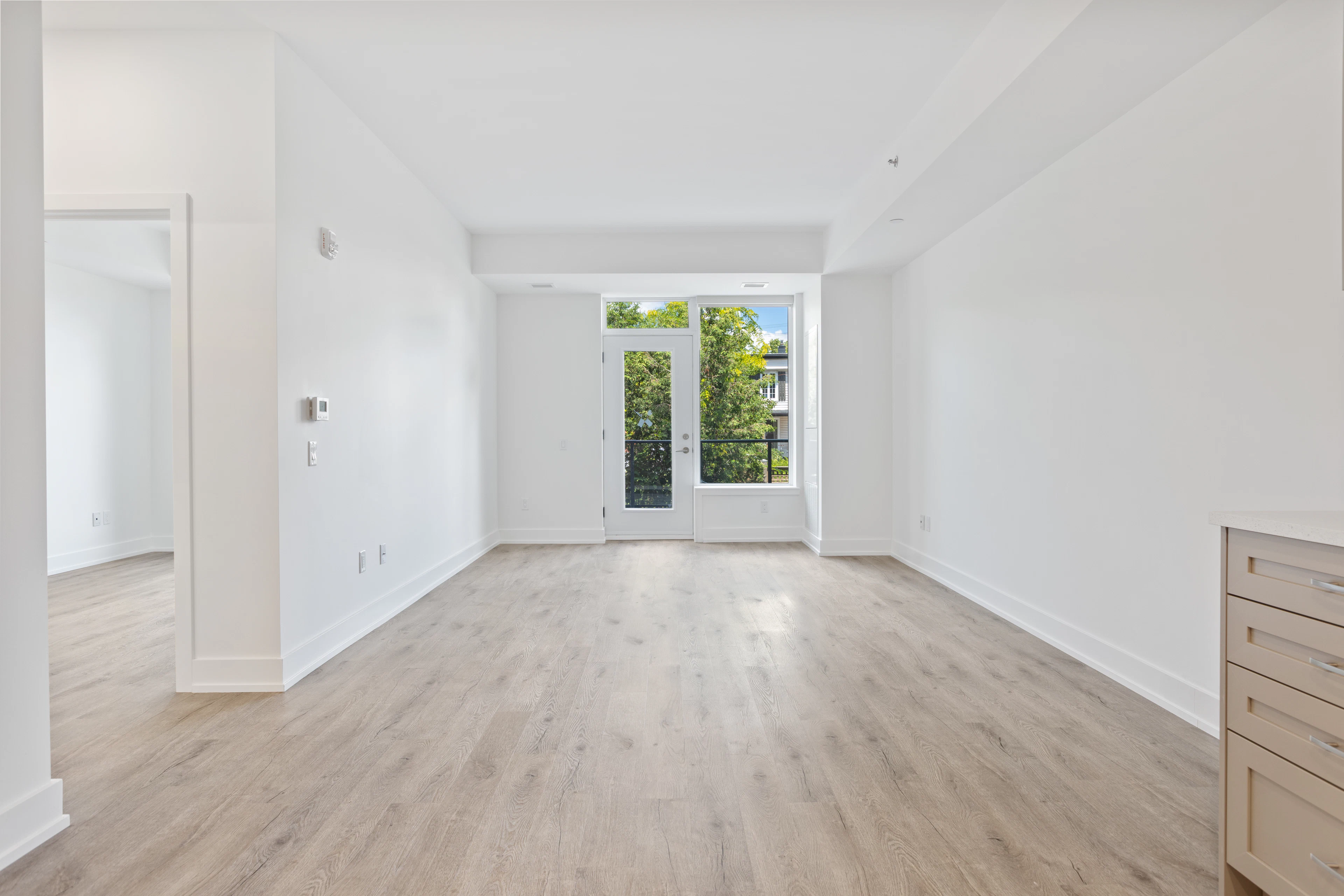 Long empty room with doors onto a balcony