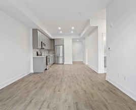 brown wooden parquet floor and white wall