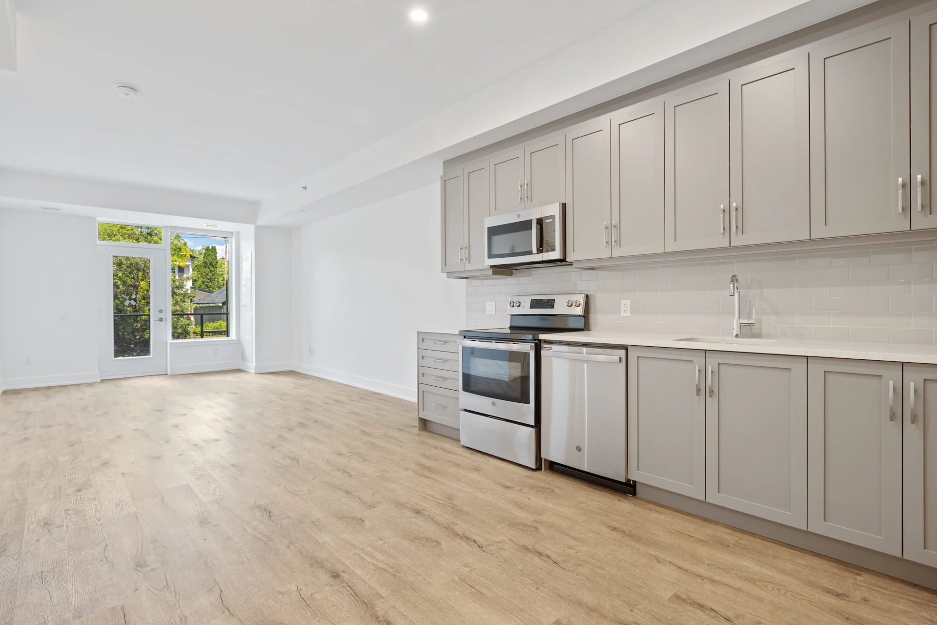 white wooden kitchen cabinet near white wall