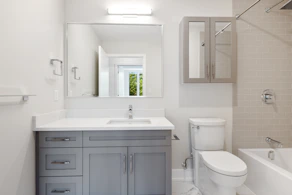 white ceramic sink beside white ceramic toilet bowl