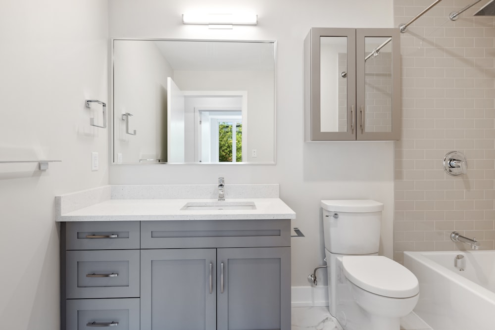 Lavabo en céramique blanche à côté de la cuvette de toilette en céramique blanche