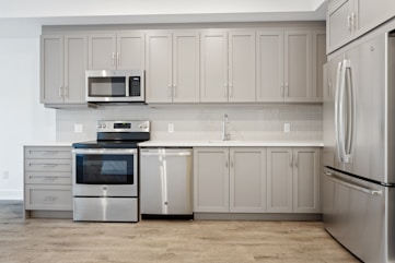 white microwave oven on white wooden cabinet
