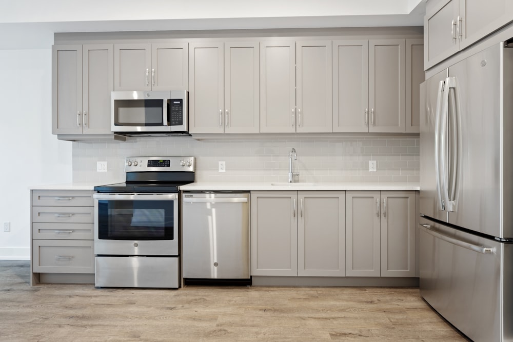 white microwave oven on white wooden cabinet