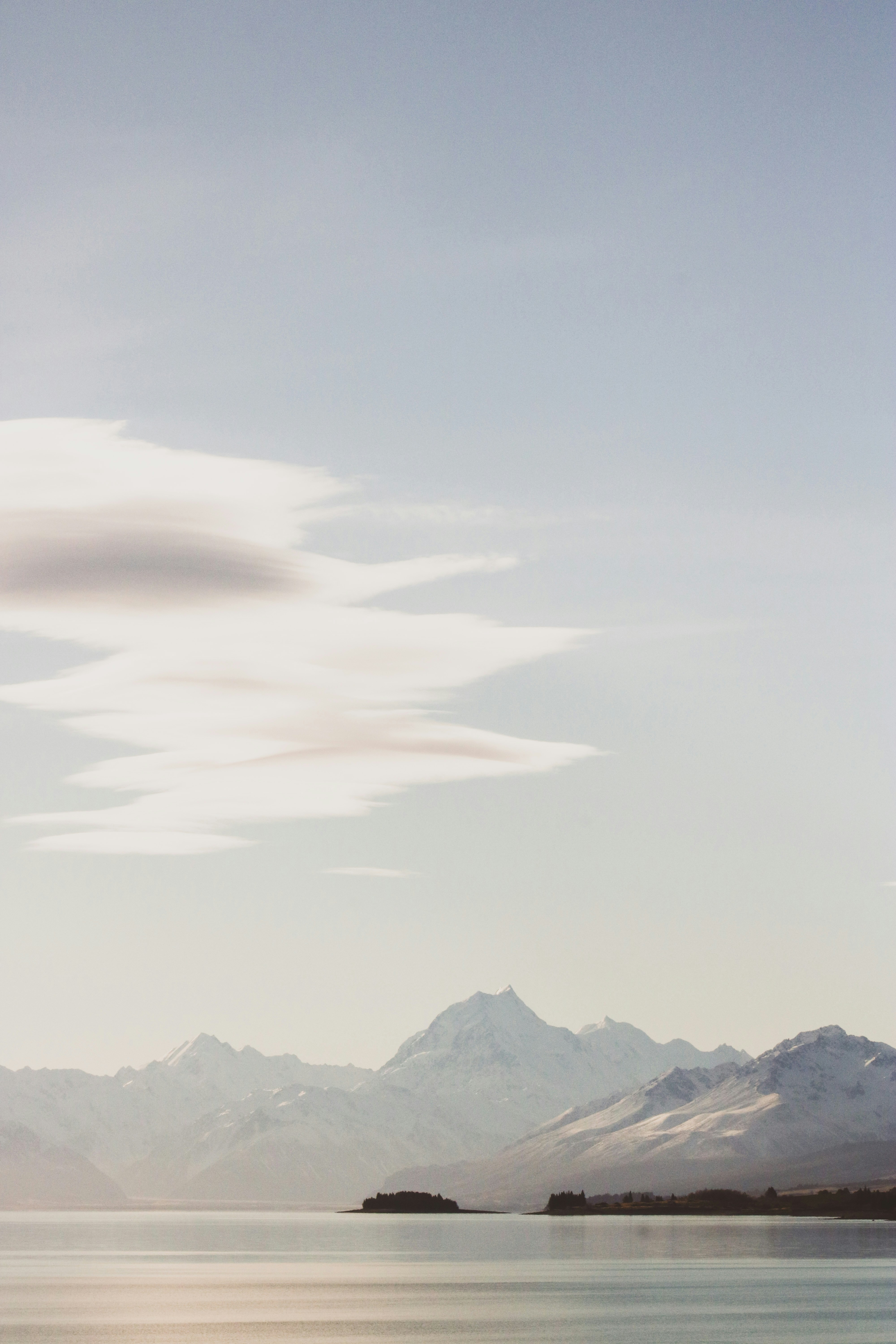 Snow covered mountains under white cloudy sky during daytime photo ...
