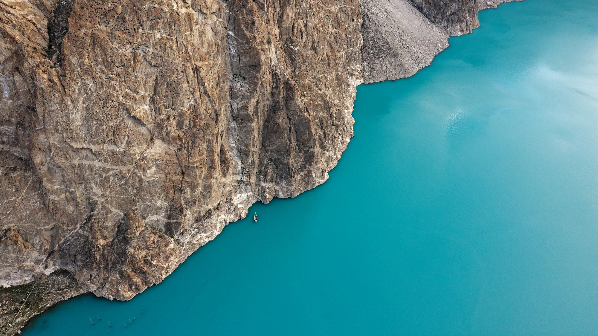 The turquoise water of Attabad Lake against bare rock, Hunza