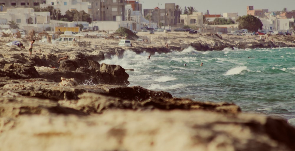 brown and white concrete buildings beside sea during daytime