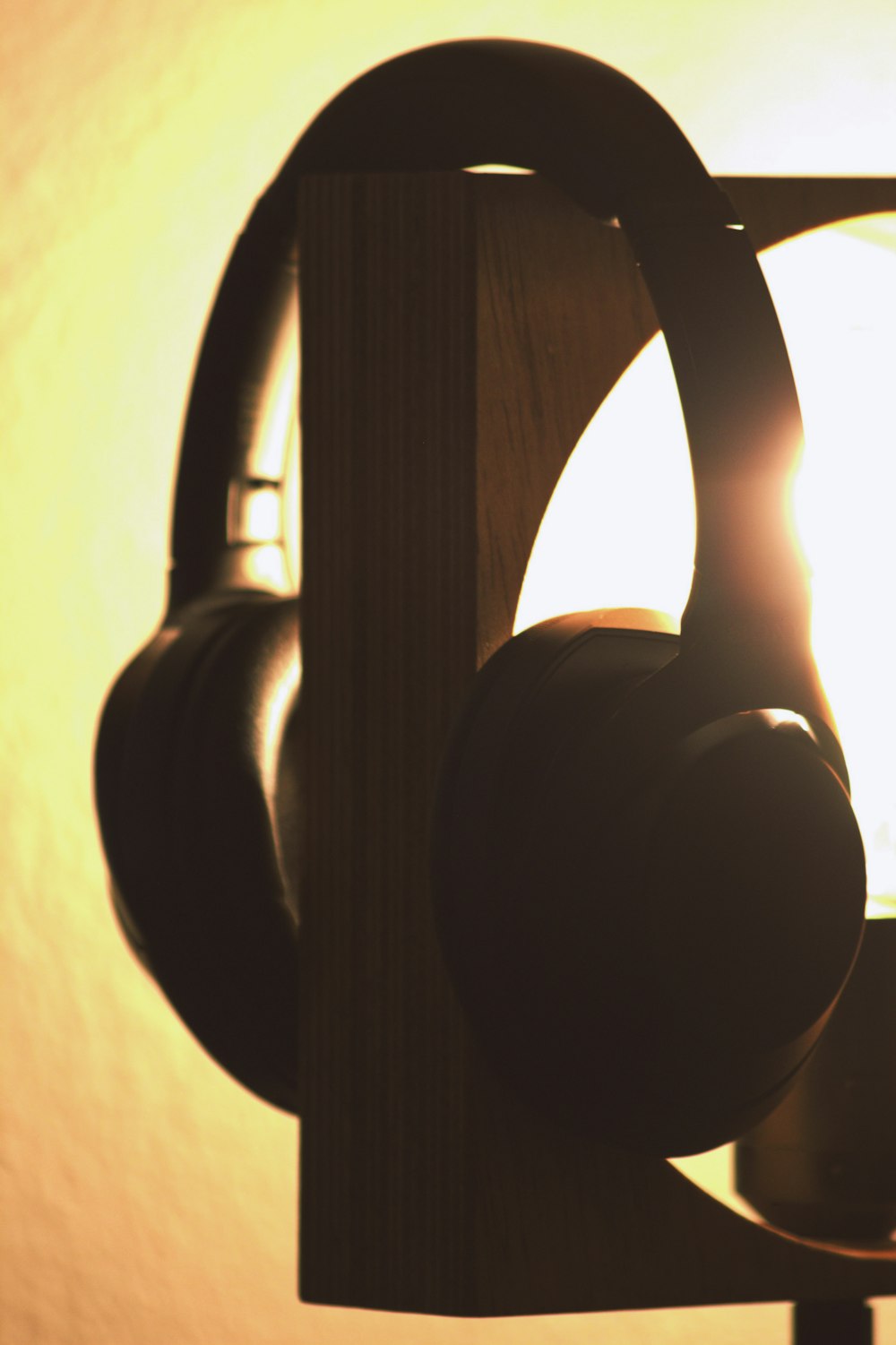 black headphones on brown wooden table