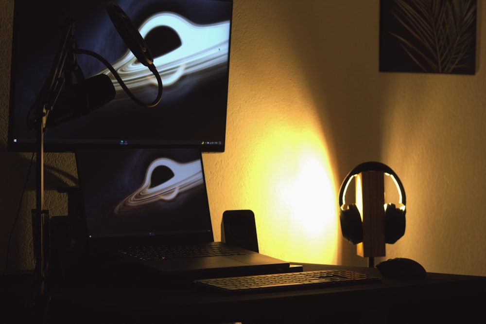 black flat screen computer monitor turned on beside black computer keyboard