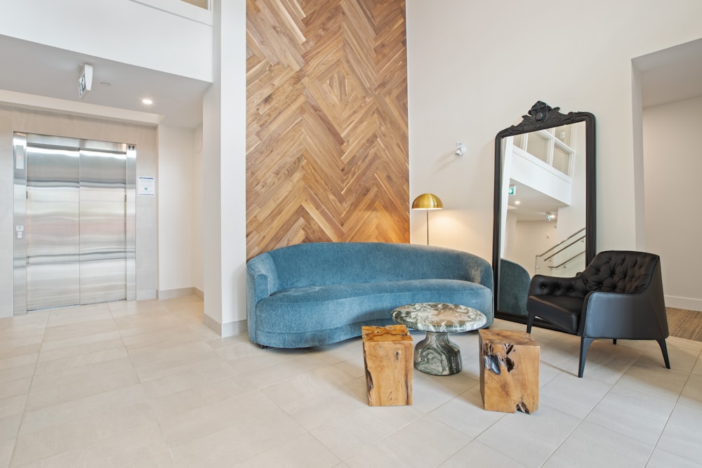 blue sofa beside brown wooden cabinet