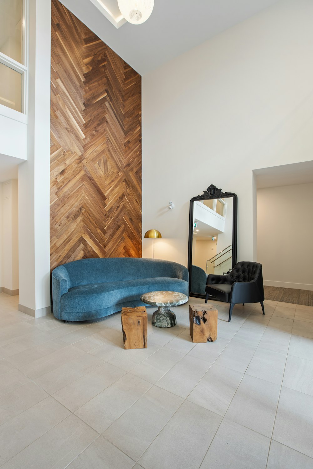 blue cushion couch beside brown wooden door