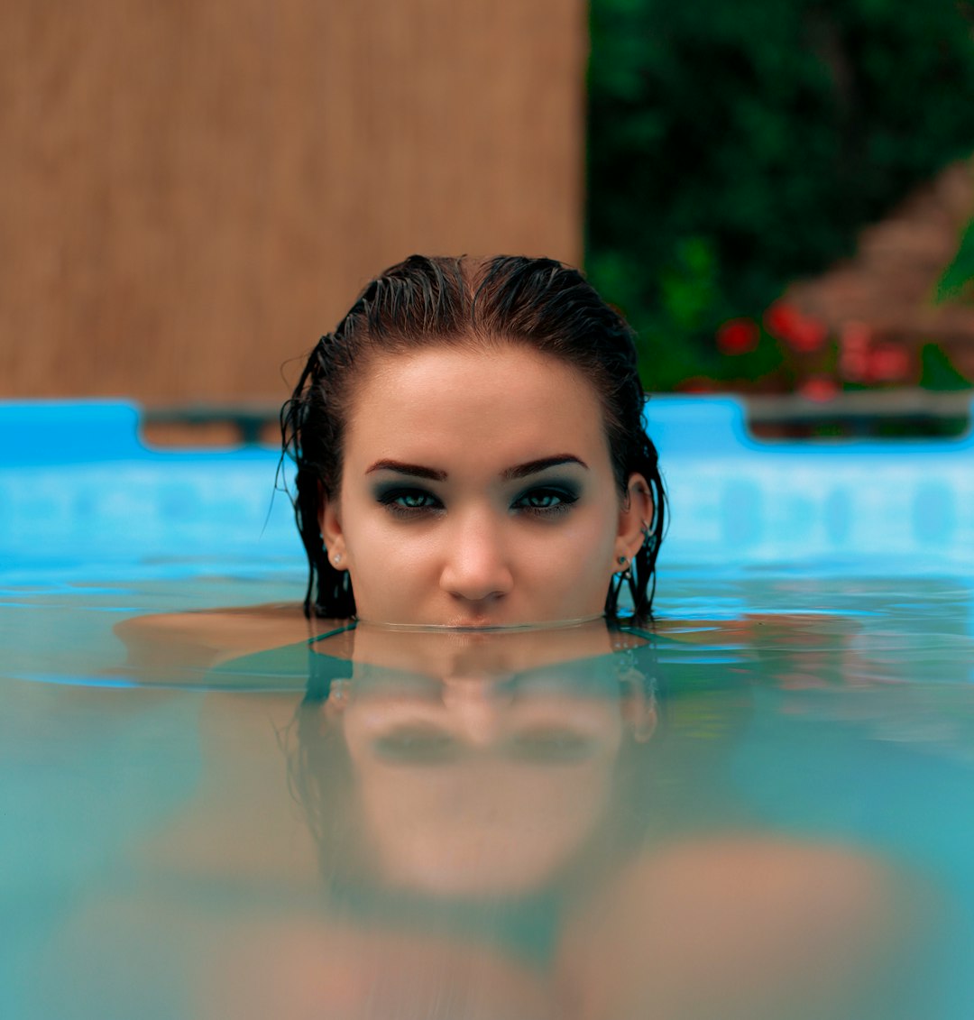 woman in swimming pool during daytime
