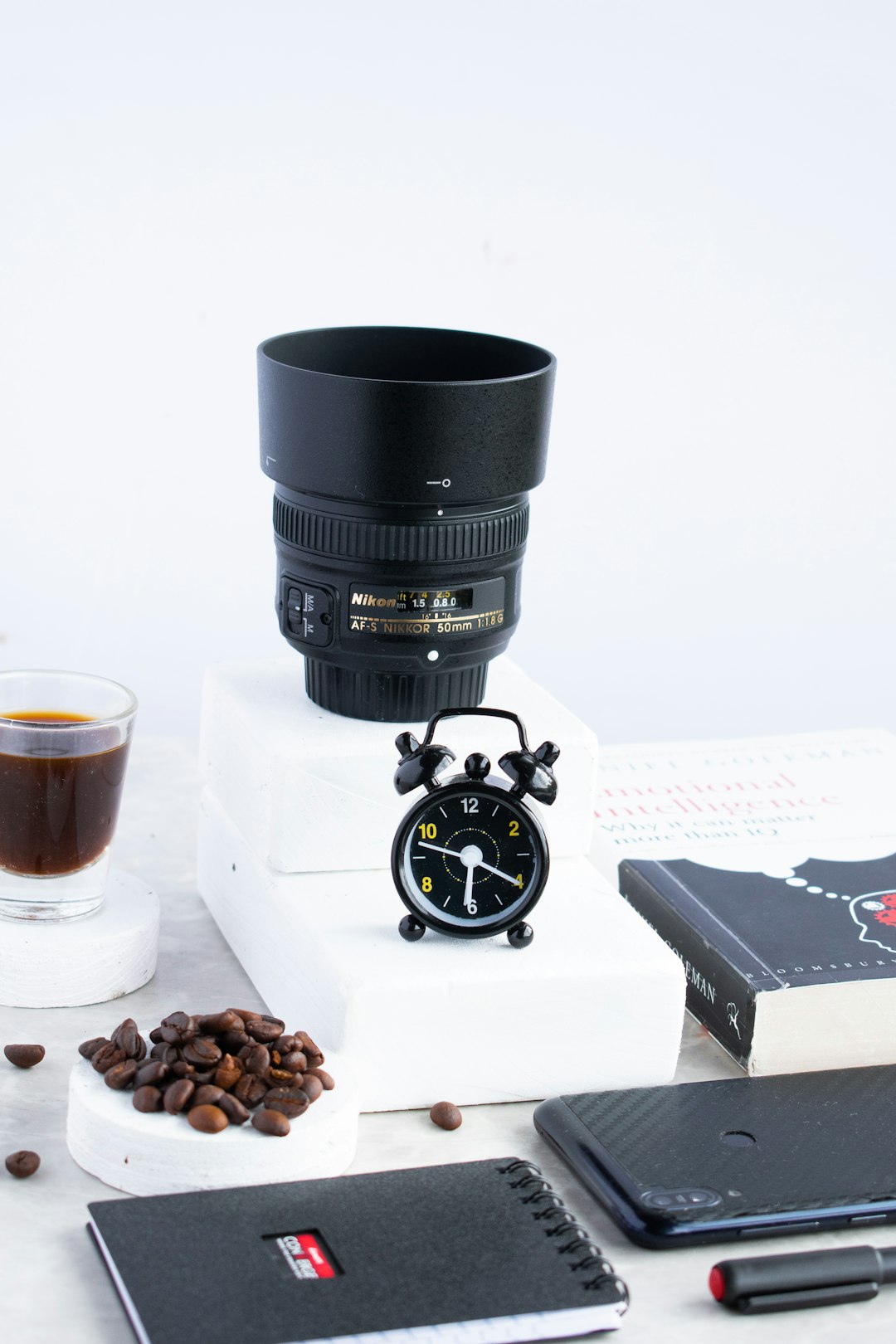 black camera lens beside brown and white coffee beans