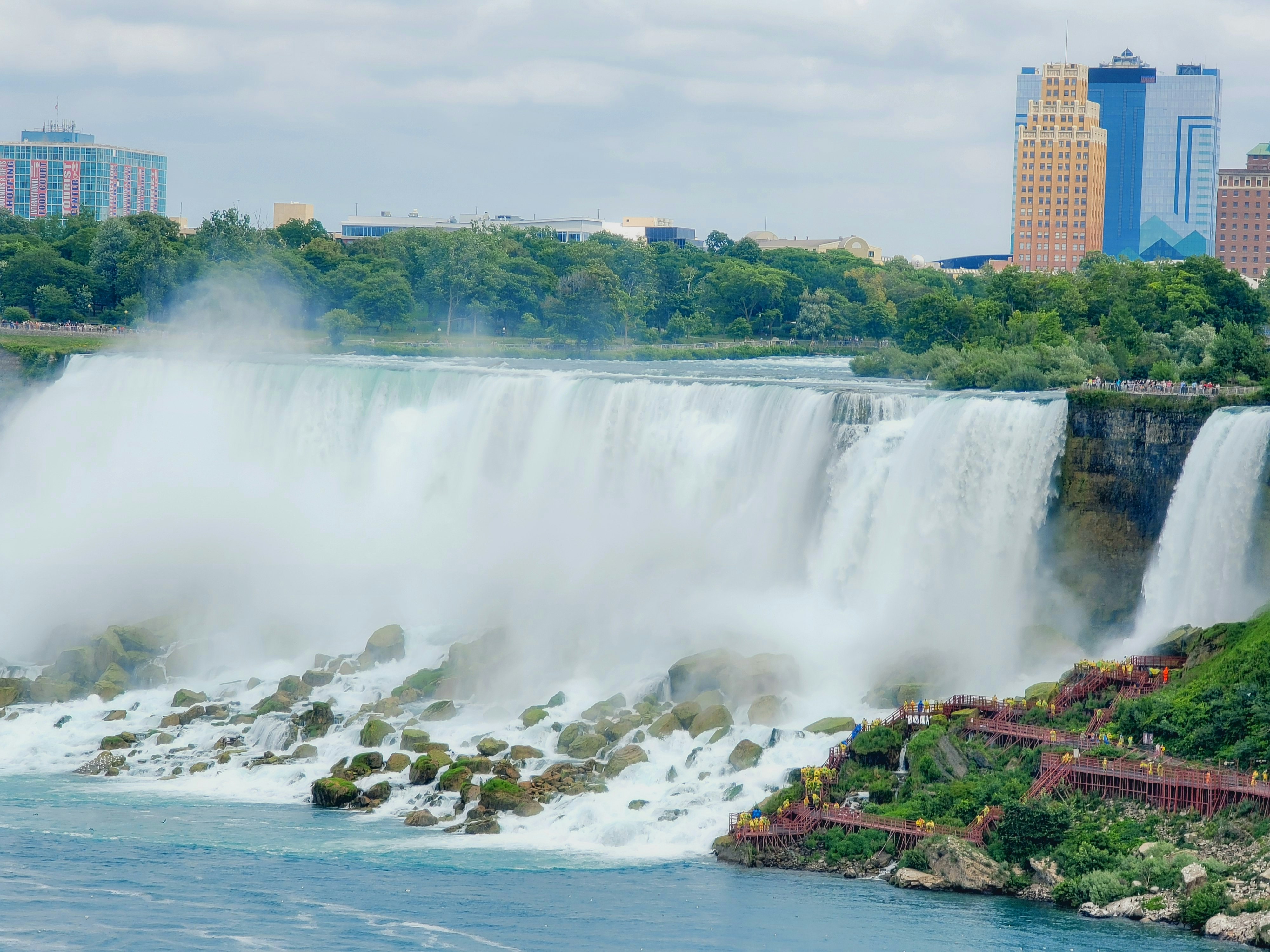 water falls near brown concrete building during daytime