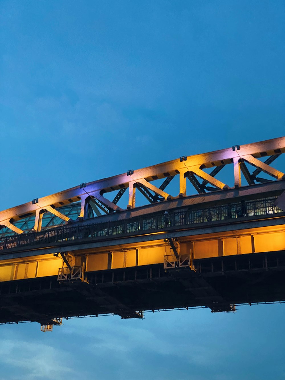 yellow and gray bridge under blue sky