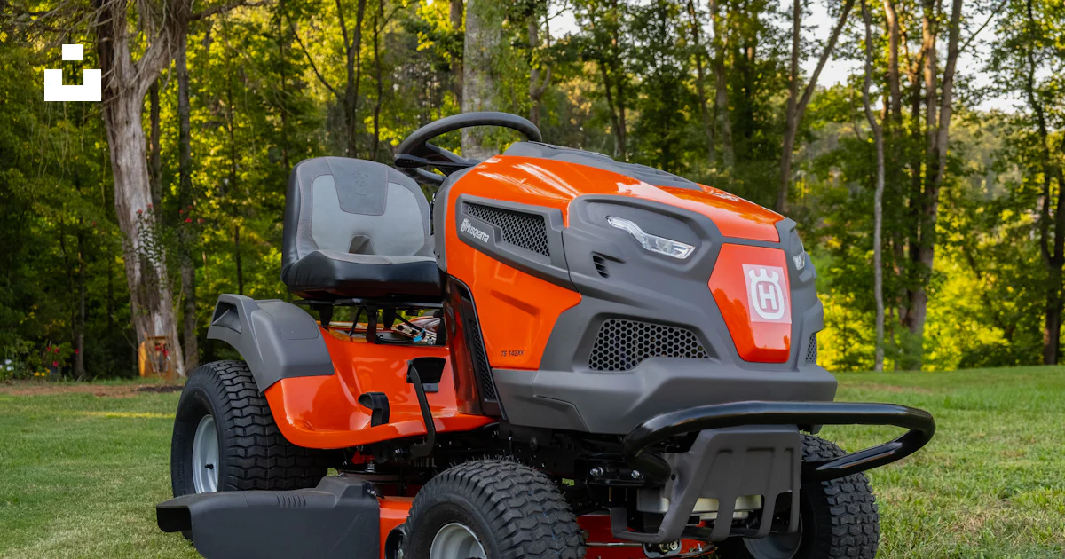 Orange and black ride on lawn mower on green grass field during daytime ...