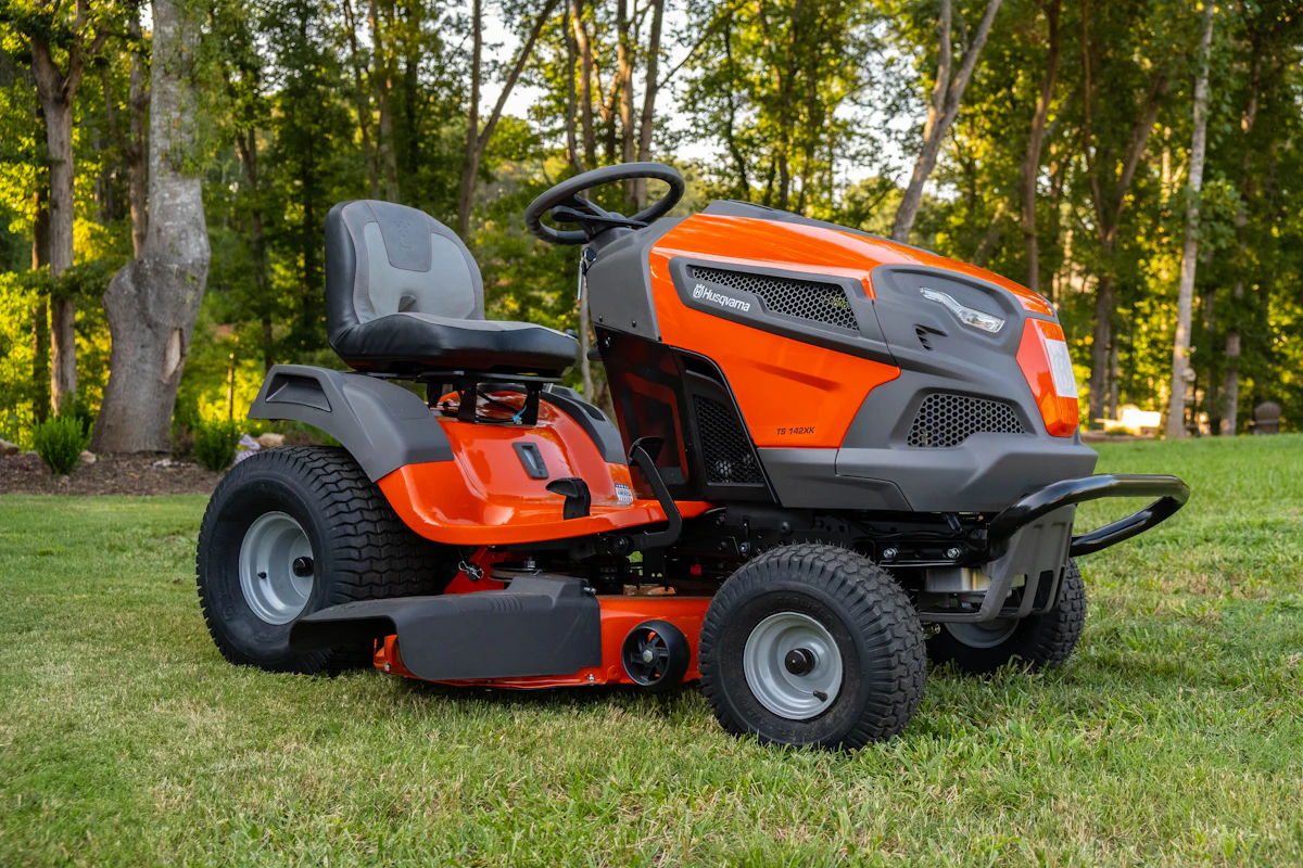 An orange lawn tractor on a lawn