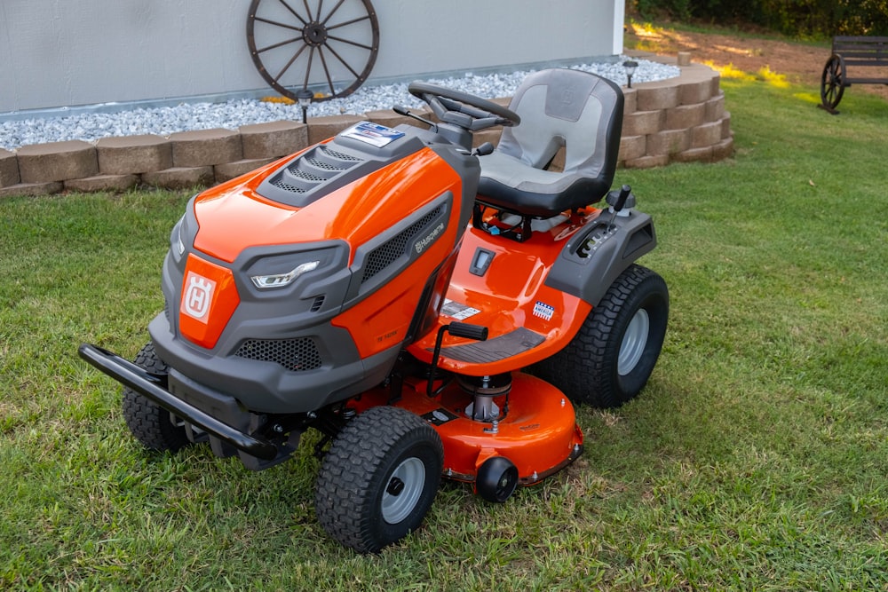 orange and black ride on lawn mower