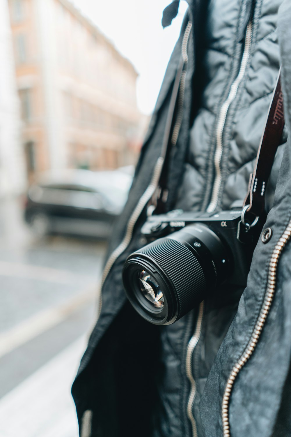 black dslr camera on black leather jacket