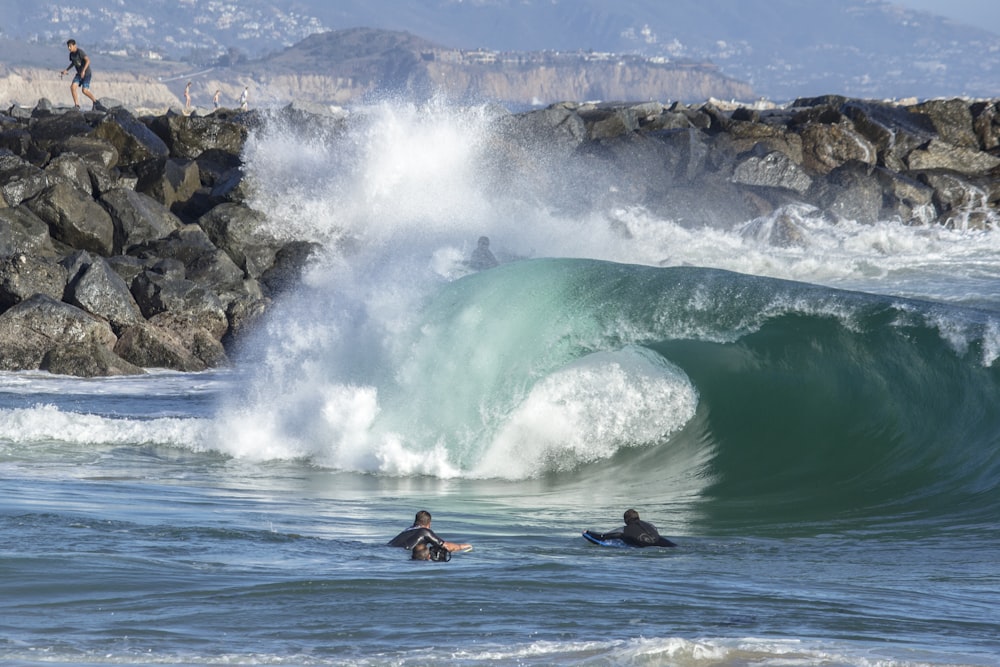 person surfing on sea waves during daytime