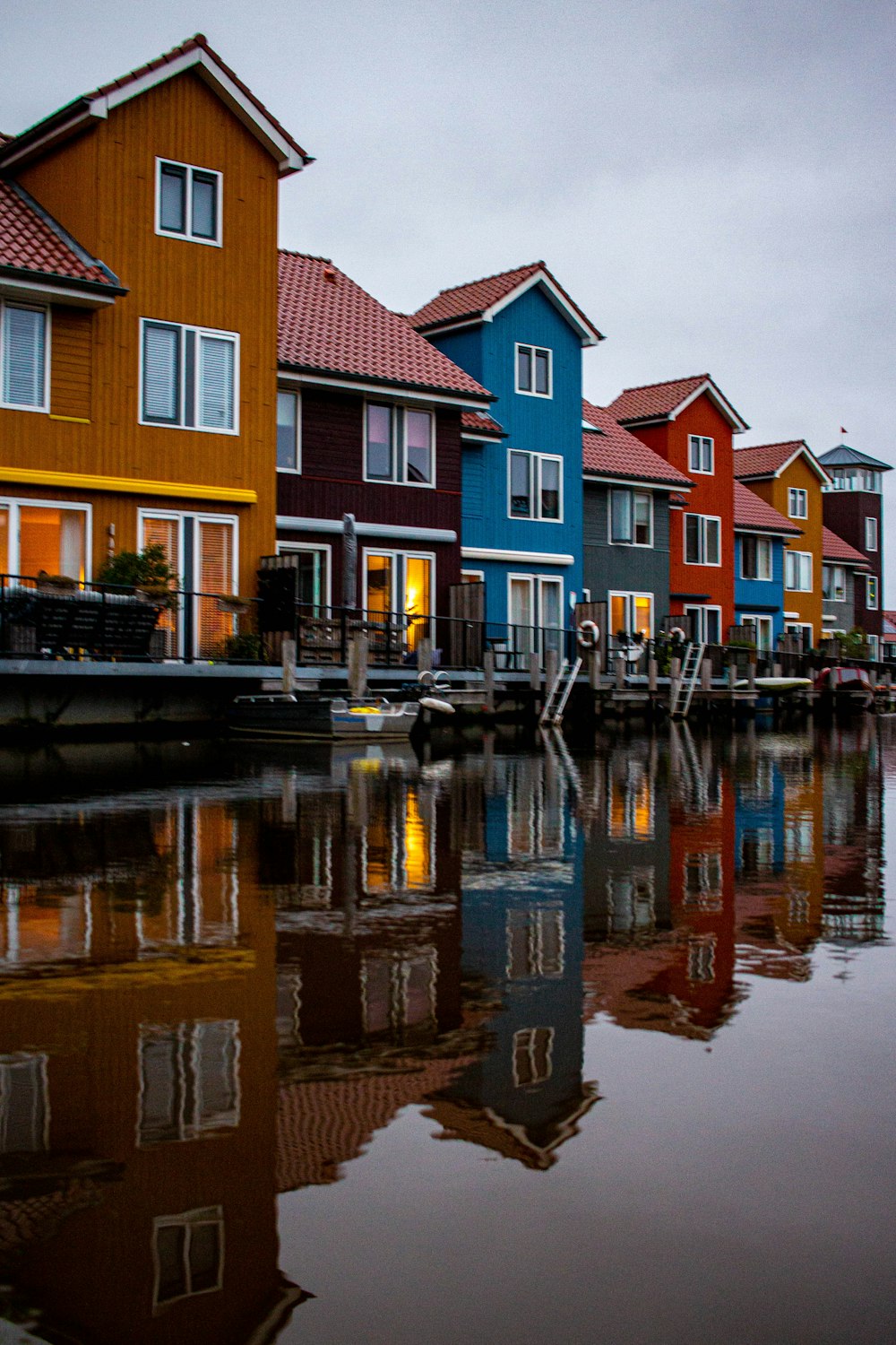 brown and white concrete houses beside river during daytime